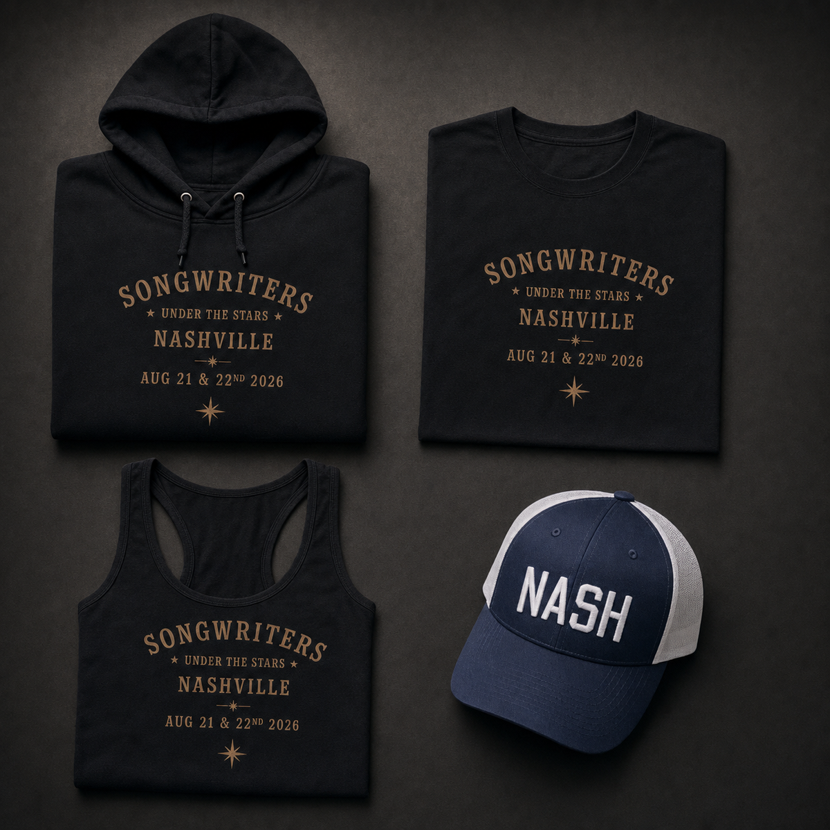 Songwriters Under The Stars tribute collection flat lay: folded black hoodie, t-shirt, and women's tank top each printed with gold Songwriters Under The Stars Nashville Aug 21 & 22nd 2026 text, alongside a navy and white two-tone trucker cap embroidered NASH in white block letters