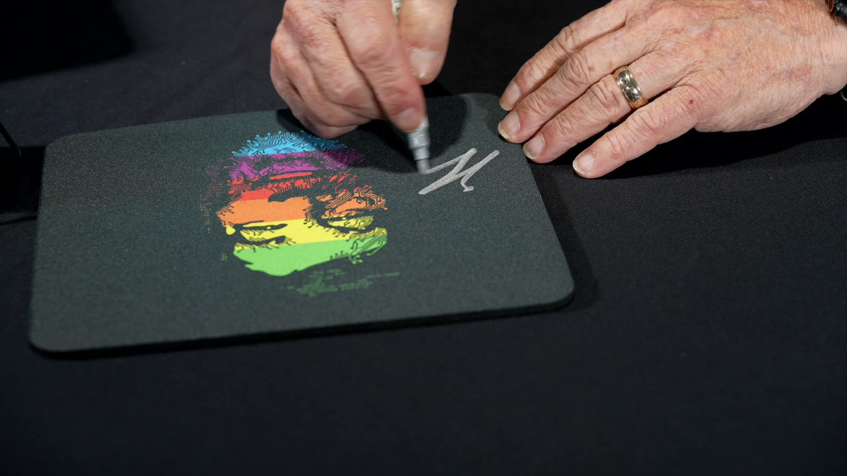 Steve Wozniak signing a WOZ branded mousepad